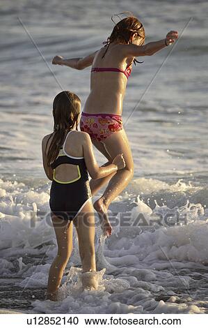beach, young, surf, enjoying, girls, two View Large Photo Image Stock Image - beach, young, surf, enjoying, girls, two. Fotosearch