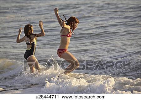beach, young, surf, enjoying, girls, two View Large Photo Image Stock Image - beach, young, surf, enjoying, girls, two. Fotosearch