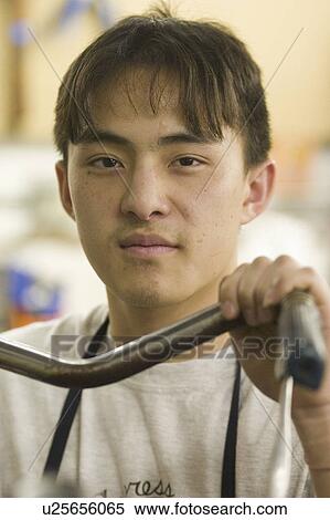Stock Photography - bicycle, asian, holding, repairman, american, portrait. Fotosearch