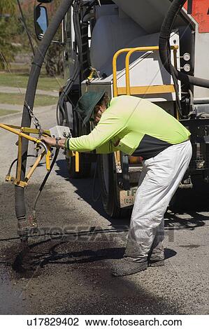 Stock Image - bitumen, repairing, asphalt, repair, road, worker. Fotosearch