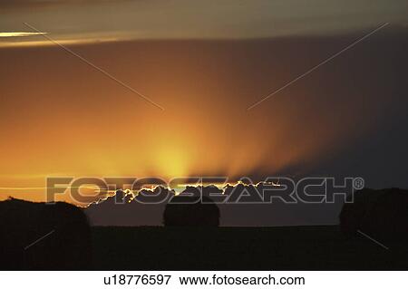 Stock Photo - clouds, sun, storm, out, peaking, setting. Fotosearch