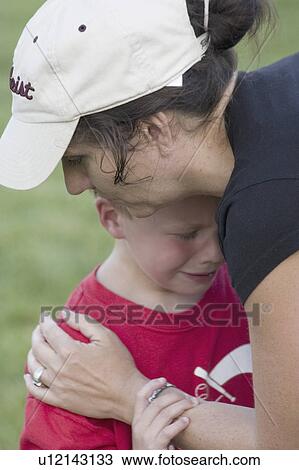 Stock Image - comforting, playing, soccer, injured, mom. Fotosearch