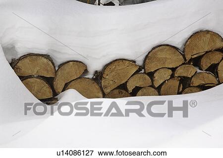 Stock Photo - covered, pile, wood, fire, snow. Fotosearch