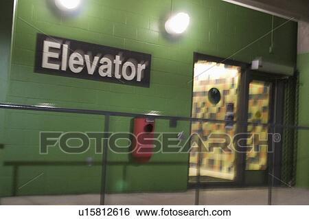 Stock Photograph - door, elevator, lot, parking, sign, blurry. Fotosearch