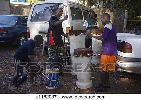 Stock Image - drummers, holder, carpark, busking, african. Fotosearch