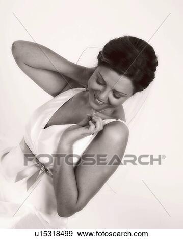Stock Photo - examing, wedding, necklace, bride. Fotosearch
