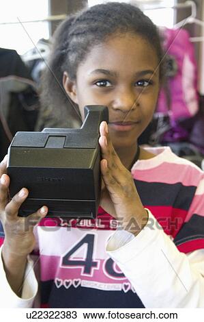Stock Image - express, holding, youth, camera, polaroid, girl. Fotosearch