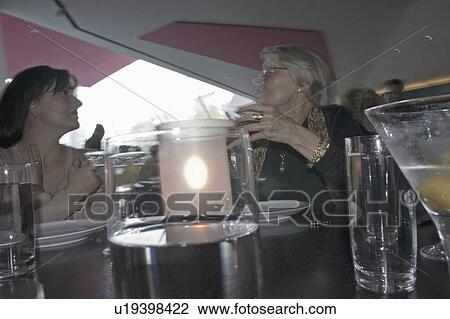Stock Image - females, conversation, good, enjoying, women. Fotosearch