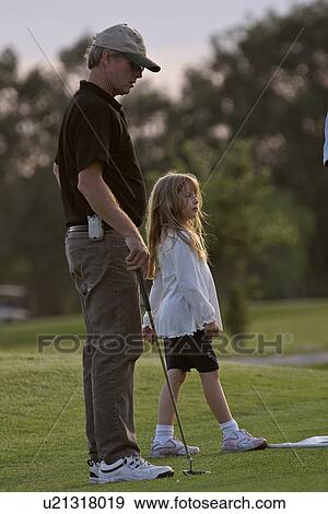 Stock Photo - golf, girl, day, enjoying, father, little. Fotosearch