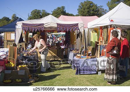 Stock Photograph - ladies, market, shopkeeper, customer, stall, shoppers. Fotosearch