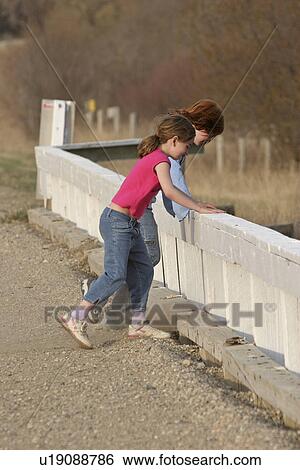 Stock Photograph - looking, saskatchewan, scenic, bridge, girls. Fotosearch