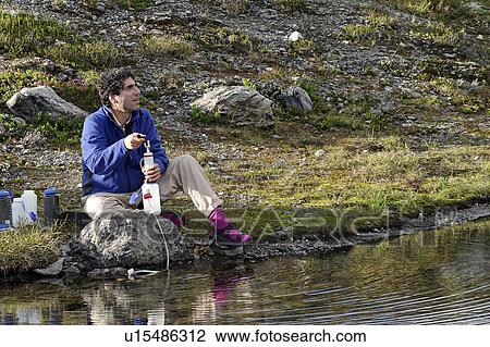 Stock Image - released, lake, sitting, male, model. Fotosearch