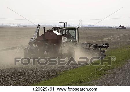 Stock Image - saskatchewan, busy, scenic, seeding, spring, farmer. Fotosearch