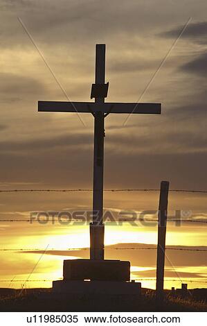 Stock Photography - scenic, cross, sun, setting, silhouetted, cemetery. Fotosearch