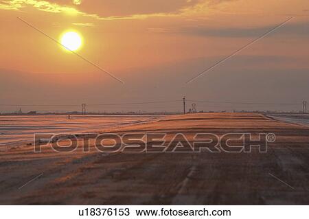 Stock Image - scenic, snow, sun, setting, lit, blowing. Fotosearch