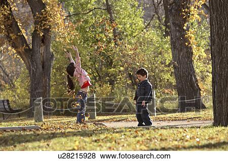 scenic, tossing, leaves, autumn, up, siblings View Large Photo Image Stock Photo - scenic, tossing, leaves, autumn, up, siblings. Fotosearch