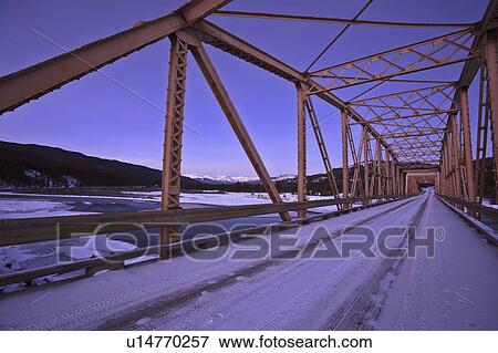 Stock Photo - snow, bridge, tracks, tire, single, orange. Fotosearch