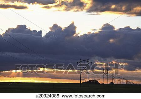 Stock Photography - sun, clouds, setting, sunset, saskatchewan, colorful. Fotosearch