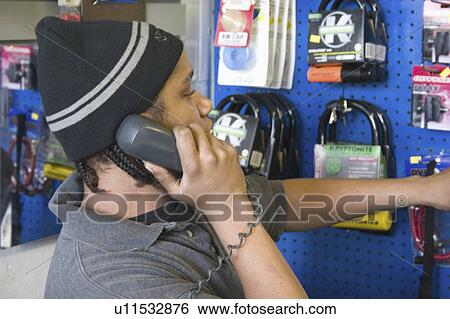 Stock Photograph - youth, shop, telephone, worker, repair, bicycle. Fotosearch