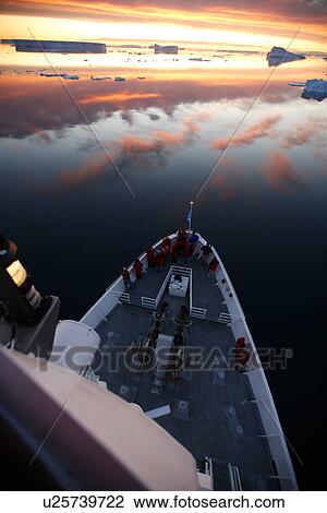 Stock Image - A view from the crow's nest of the National Geographic Endeavour at sunset in the Weddell Sea, Antarctica.. Fotosearch