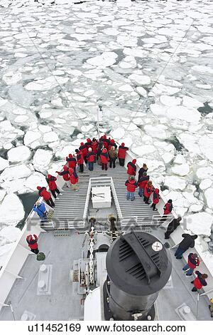 A view from the crow's nest of the Lindblad expedition ship National Geographic Endeavour operating in shore fast ice in Port Foster within the caldera at Deception Island, South Shetland Island Group, Antarctica. View Large Photo Image Stock Photo - A view from the crow's nest of the Lindblad expedition ship National Geographic Endeavour operating in shore fast ice in Port Foster within the caldera at Deception Island, South Shetland Island Group, Antarctica.. Fotosearch