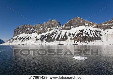 Stock Photo - A view of the towering cliff and glacier in Hornsund (Horn Sound) on the southwestern side of Spitsbergen Island in the Svalbard Archipelago, Barents Sea, Norway.. Fotosearch