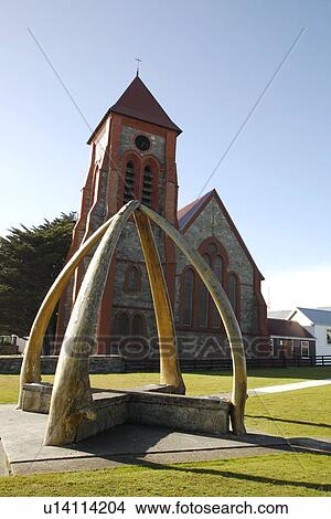 Picture - Blue whale jawbones (mandibles) create an arch in the park in Port Stanley on East Falkland Island in the Falkland Islands Group, South Atlantic Ocean.. Fotosearch
