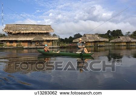 Stock Image - Canoe and Uakari floating lodge ecoresort, Mamiraua sustainable development reserve, Amazonas, Brazil. Fotosearch