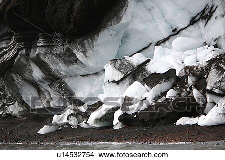 Picture - Close up views of glacial ice and ash after the 1969 eruption on Deception Island in Antarctica. Note the melting ice dropping suspended ash onto the beach.. Fotosearch