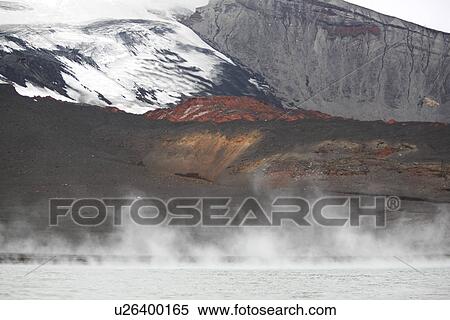 Close up views of glacial ice and ash after the 1969 eruption on Deception Island in Antarctica. Here thermal energy sends steam up in the seawater surrounding the recent ash flow. View Large Photo Image Stock Photography - Close up views of glacial ice and ash after the 1969 eruption on Deception Island in Antarctica. Here thermal energy sends steam up in the seawater surrounding the recent ash flow.. Fotosearch