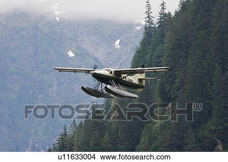 Flightseeing float planes in and out of the "Punchbowl" rock formation in Kynoch Inlet in Misty Fjords National Monument in Southeast Alaska, USA. Pacific Ocean. View Large Photo Image Picture - Flightseeing float planes in and out of the "Punchbowl" rock formation in Kynoch Inlet in Misty Fjords National Monument in Southeast Alaska, USA. Pacific Ocean.. Fotosearch