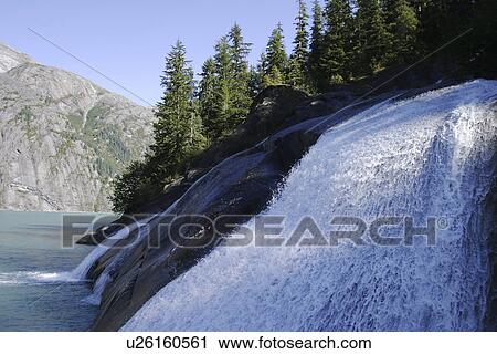 Glacier melt water forms a small waterfall in Tracy Arm in southeast Alaska, USA. X View Large Photo Image Stock Image - Glacier melt water forms a small waterfall in Tracy Arm in southeast Alaska, USA. X. Fotosearch