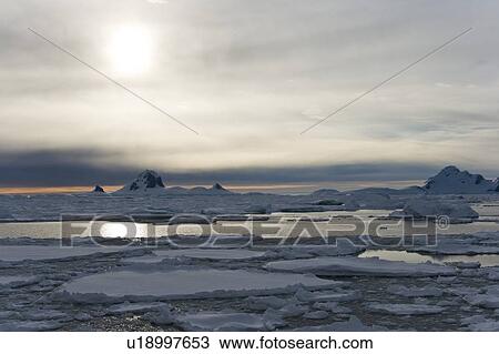 Stock Image - Iceberg detail in and around the Antarctic Peninsula during the summer months. More icebergs are being created as global warming is causing the breakup of major ice shelves and glaciers.. Fotosearch