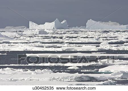 Stock Photography - Iceberg detail in and around the Antarctic Peninsula during the summer months. More icebergs are being created as global warming is causing the breakup of major ice shelves and glaciers.. Fotosearch