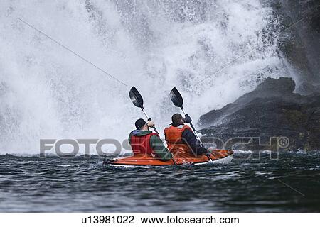 Stock Image - Kayaking in Red Bluff Bay on Baranof Island in Southeast Alaska, USA. Pacific Ocean. Kayak property release is DB051905. Model released numbers BM0807, JP0807, or DP0807.. Fotosearch