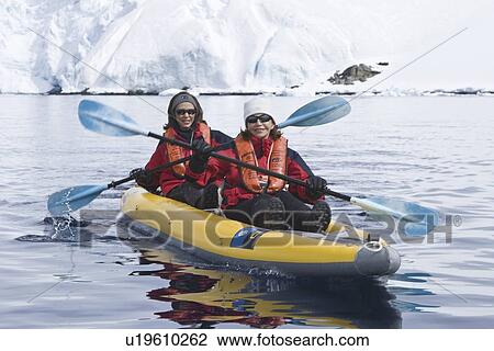 Stock Image - Lindblad Expeditions guests kayaking among the ice in Antarctica as part of expedition travel. NO MODEL RELEASES FOR THIS IMAGE.. Fotosearch