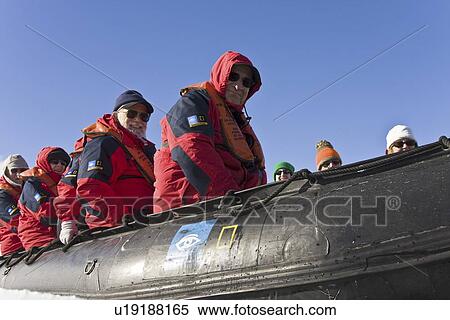 Stock Photography - Lindblad Expeditions guests on Zodiac tour in Antarctica as part of expedition travel. NO MODEL RELEASES FOR THIS IMAGE.. Fotosearch