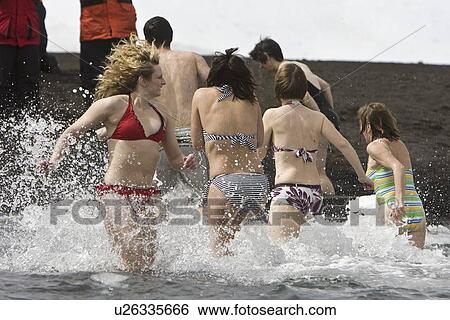 Lindblad Expeditions guests taking the "polar plunge" in Foster Harbour on Deception Island in Antarctica as part of expedition travel. NO MODEL RELEASES FOR THIS IMAGE. View Large Photo Image Stock Photograph - Lindblad Expeditions guests taking the "polar plunge" in Foster Harbour on Deception Island in Antarctica as part of expedition travel. NO MODEL RELEASES FOR THIS IMAGE.. Fotosearch