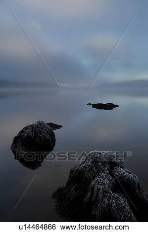 Loch Awe on a misty frosty morning, rocks in foreground, facing west. Argyll, Scotland View Large Photo Image Stock Photograph - Loch Awe on a misty frosty morning, rocks in foreground, facing west. Argyll, Scotland. Fotosearch