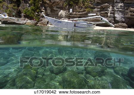 Over under of banca and sandy seafloor, Apo island Marine Reserve, Philippines View Large Photo Image Stock Image - Over under of banca and sandy seafloor, Apo island Marine Reserve, Philippines. Fotosearch