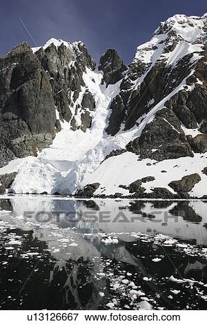 Reflections and snow covered mountains in Lemaire Channel in Antarctica. View Large Photo Image Stock Photo - Reflections and snow covered mountains in Lemaire Channel in Antarctica.. Fotosearch