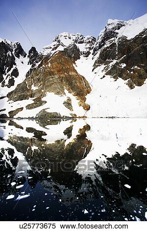 Reflections and snow covered mountains in Lemaire Channel in Antarctica. View Large Photo Image Stock Photography - Reflections and snow covered mountains in Lemaire Channel in Antarctica.. Fotosearch