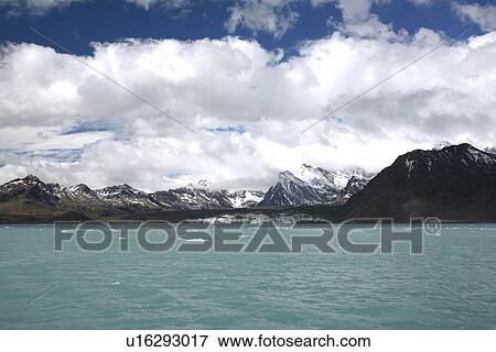 Stock Photo - scenic, Neumayer Glacier, Glacier, ice, calving, global warming, receding glacier, crevasse, spire, pinnacle, blue, moraine, lateral moraine, tidewater, tidewater glacier, South Georgia Island, South Georgia, South Atlantic Ocean, Atlantic Ocean, MARINE, . Fotosearch