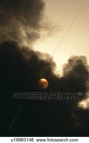 Smoke covering sun from oil refinery on fire. Island in Arabian Gulf View Large Photo Image Stock Photo - Smoke covering sun from oil refinery on fire. Island in Arabian Gulf. Fotosearch