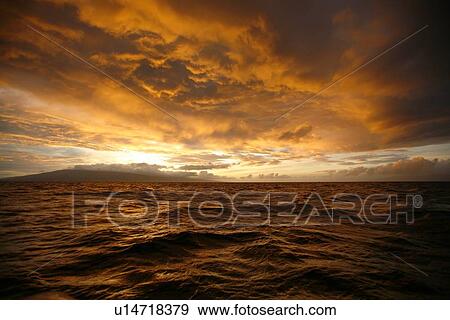 Stock Photo - Sunset across the AuAu Channel between Maui and Lanai, looking west with Lanai in the background. Maui, Hawaii, USA.. Fotosearch