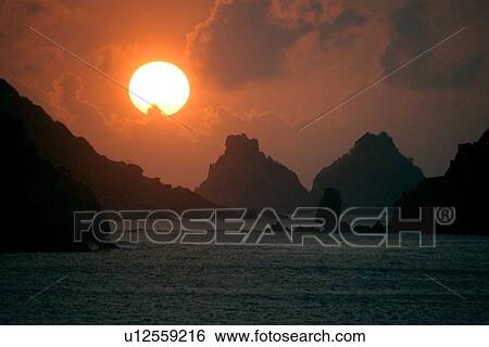 Stock Photograph - Sunset and Dois Irmaos islands, Fernando de Noronha national marine sanctuary, Pernambuco, Brazil (S. Atlantic). Fotosearch