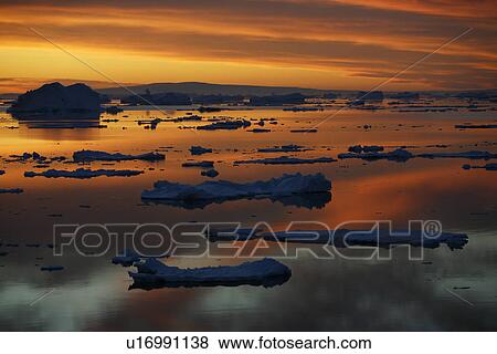 Sunset on fresh sea ice and tabular icebergs in the Weddell Sea, Antarctica. View Large Photo Image Stock Photo - Sunset on fresh sea ice and tabular icebergs in the Weddell Sea, Antarctica.. Fotosearch