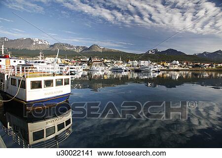 Stock Image - The harbor at Ushuaia, Argentina on a very rare calm and sunny day. Ushuaia claims to be the southernmost city in the world.. Fotosearch