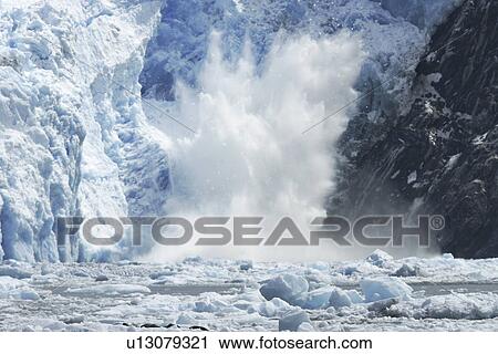 Stock Image - The Sawyer Glacier calving, a tidewater glacier at the end of Tracy Arm in Southeast Alaska, USA.. Fotosearch