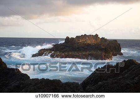 Stock Photograph - Wave crashing over South islet, St. Peter and St. Paul's rocks, Brazil, Atlantic Ocean . Fotosearch